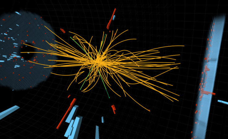 Two high-energy photons shown as red towers are smashed together in the LHC. The yellow lines are the measured tracks of other particles produced in the collision -- possible evidence in the hunt for the Higgs Boson (Credit: CERN/Thomas McCauley, Lucas Taylor)