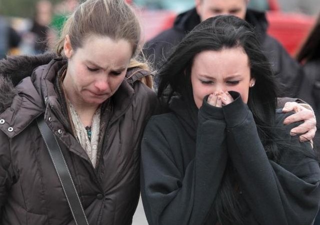 A distraught sophomore leaves school grounds with her mother following a shooting of five students at Chardon High School in Chardon on Monday, Feb. 27, 2012 (Credit: The Plain Dealer/Thomas Ondrey)