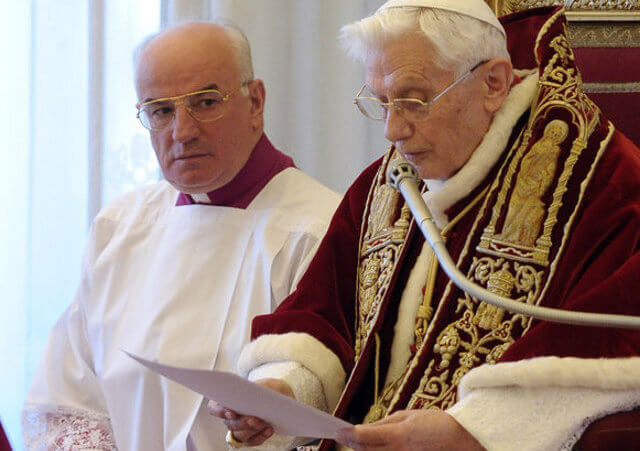 Pope Benedict XVI announcing his resignation on Monday at the Vatican. At left is Msgr. Franco Camaldo, a papal aide (Credit: L'Osservatore Romano via Associated Press)