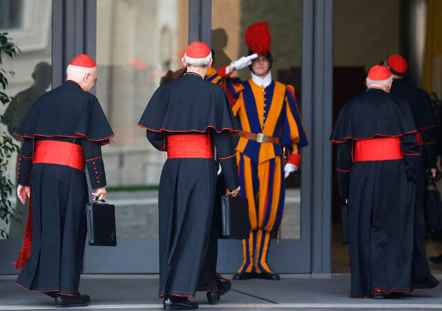 Cardinals Francis E. George of Chicago, Donald W. Wuerl of Washington and Theodore E. McCarrick, retired archbishop of Washington, arrive for a general congregation meeting in the synod hall at the Vatican March 5. The world's cardinals are meeting for several days in advance of the conclave to elect the new pope (Credit: CNS photo/Stefano Rellandini/Reuters)