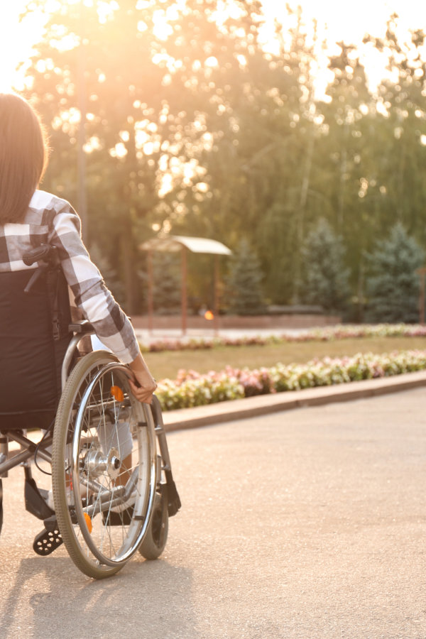 Young woman in wheelchair outdoors