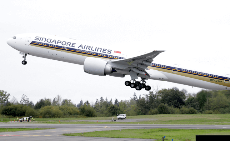 A Singapore Airlines Boeing 777-312ER takes off from Paine Field Tuesday, Sept. 17, 2013, in Everett, Wash. (AP Photo/Elaine Thompson)