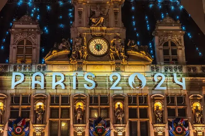 View of the colorful Paris City Hall building and Olympic sign for the Paris 2024 Olympics to illustrate the opening ceremony on July 26, 2024. By f11photo/stock.adobe.com