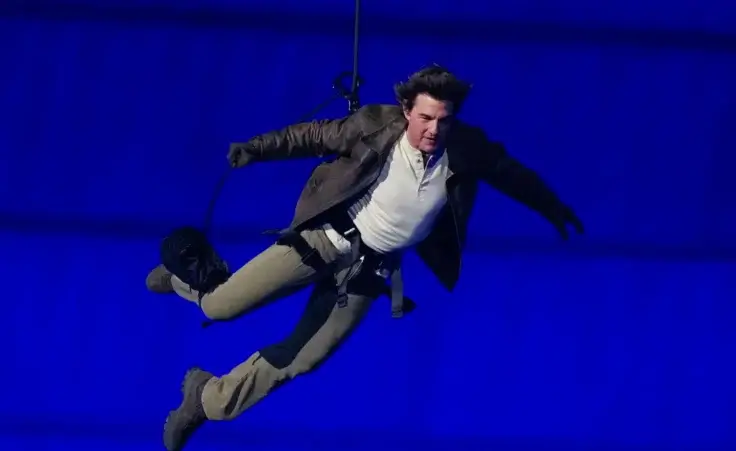 Tom Cruise is lowered on the Stade de France during the 2024 Summer Olympics closing ceremony, Sunday, Aug. 11, 2024, in Saint-Denis, France. (AP Photo/Natacha Pisarenko)