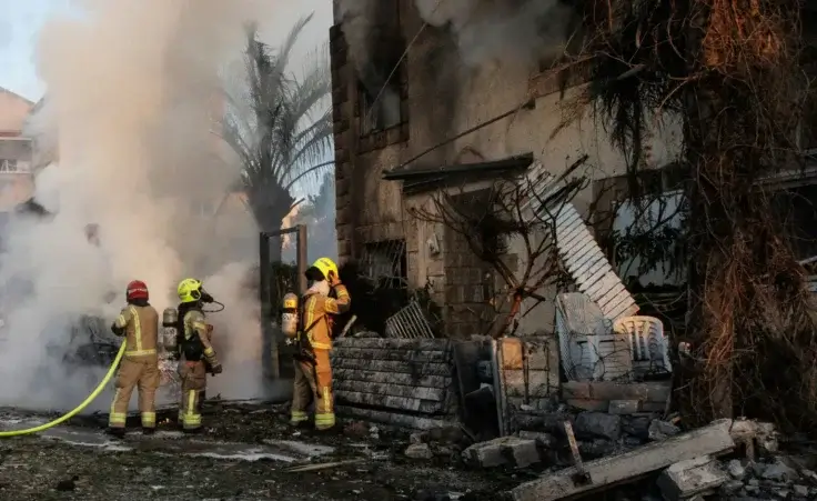 Israeli security and rescue forces work at the site hit by a rocket fired from Lebanon, in Kiryat Bialik, northern Israel, on Sunday, Sept. 22, 2024. (AP Photo/Gil Nechushtan)