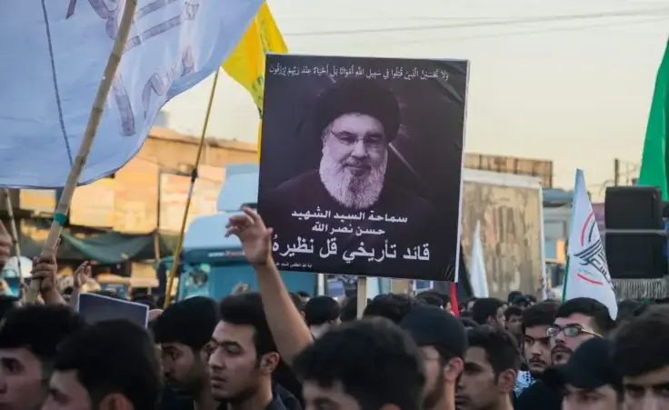 Iraqi Shiites hold pictures of Lebanon's Hezbollah leader Sayyed Hassan Nasrallah, who was killed by an Israeli airstrike in Beirut, during a symbolic funeral in Sadr City, Baghdad, Iraq, Sunday, Sept. 29, 2024. (AP Photo/Adil al-Khazali)