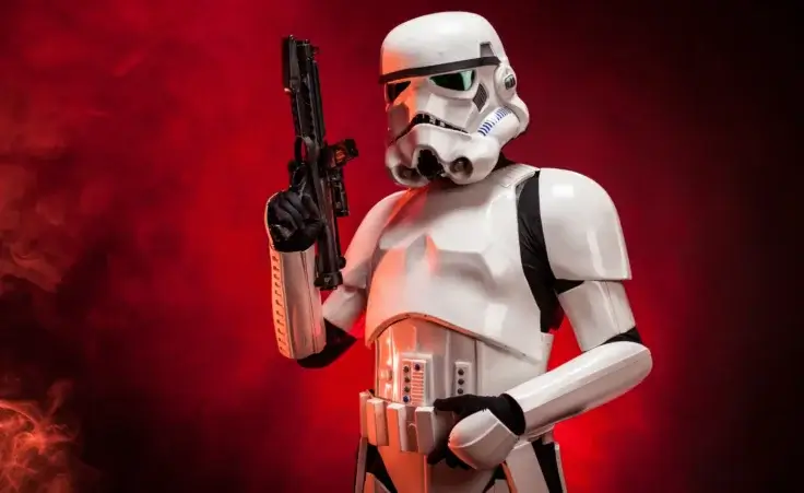 Studio portrait of stormtrooper costume replica, with blaster E-11 gun. He is a fictional character of Star Wars saga. By nnerto/stock.adobe.com. Transgender stormtrooper