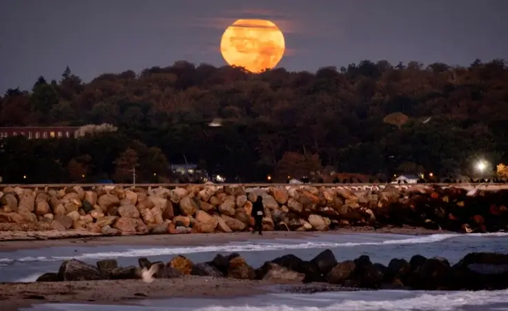 The full Hunters moon sets in Niendorf at the Baltic Sea, Germany, early Thursday, Oct. 17, 2024. (AP Photo/Michael Probst) brightest supermoon