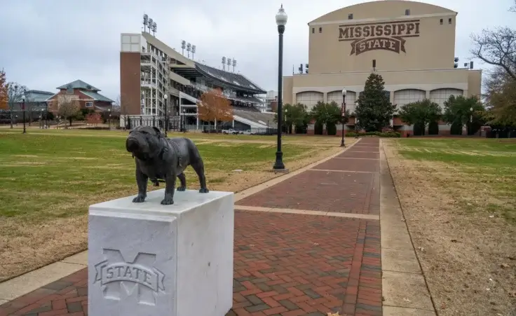 A statue of the school's mascot "Bully" sits at the Junction outside of Davis-Wade Stadium on the campus of Mississippi State University. By Stephen/stock.adobe.com.