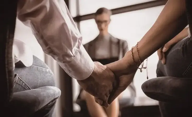 Couple holding hands with another person in the background to illustrate open marriage or polyamorous love. By vectorfusionart/stock.adobe.com