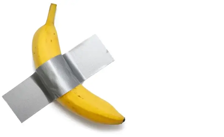 A banana duct-taped on a wall. Conceptual art. By halcon1/stock.adobe.com.