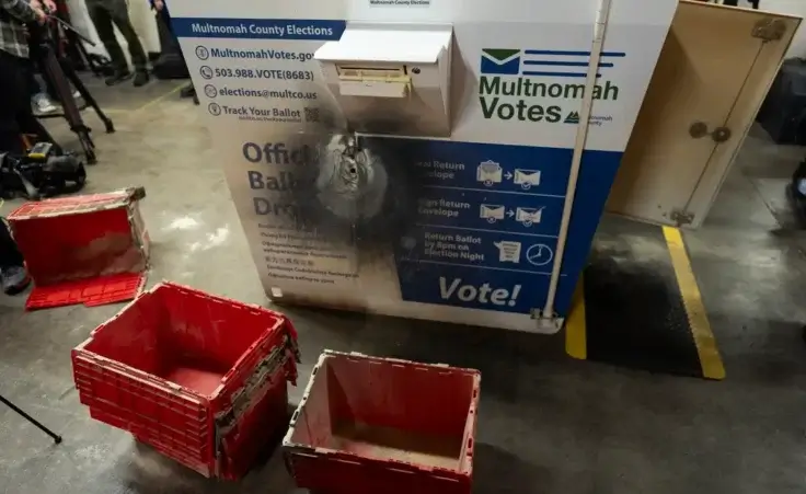 A damaged ballot drop box is displayed during a news conference at the Multnomah County Elections Division office on Monday, Oct. 28, 2024, in Portland, Ore. (AP Photo/Jenny Kane)