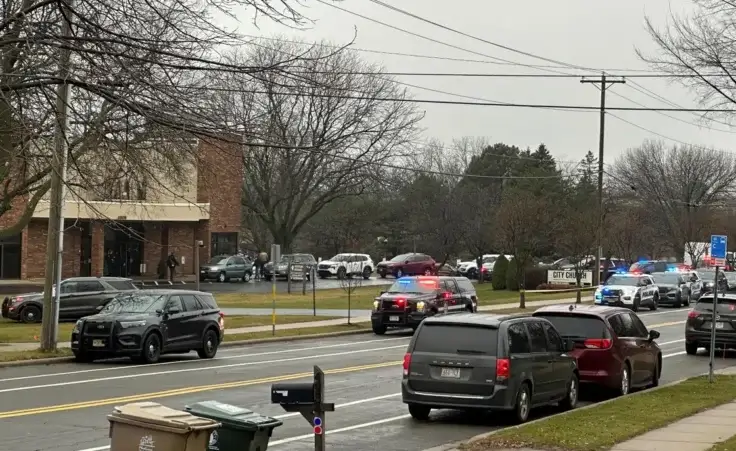 Emergency vehicles are parked outside the Abundant Life Christian School in Madison, Wis., where multiple injuries were reported following a shooting, Monday, Dec. 16, 2024. (AP Photo/Scott Bauer)