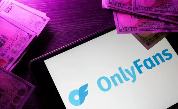 Tablet with Onlyfans logo and money. By Vitalii Vodolazskyi/stock.adobe.com