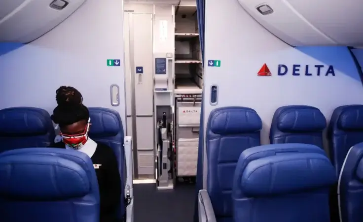 A Delta Airlines employee wears personal protective equipment after landing at Minneapolis−Saint Paul International Airport, Thursday, May 28, 2020, in Minneapolis. (AP Photo/John Minchillo) Stowaway Delta New York to Paris