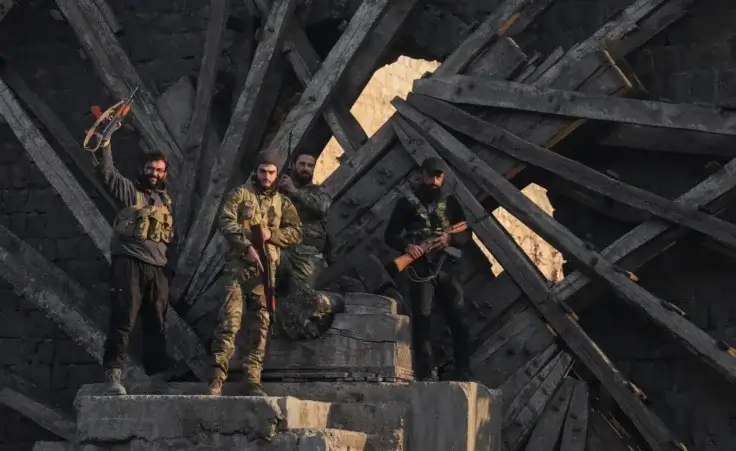 Insurgent fighters celebrate in the aftermath of the opposition's takeover of the city in downtown Hama, Syria, Friday, Dec. 6, 2024. (AP Photo/Omar Albam)