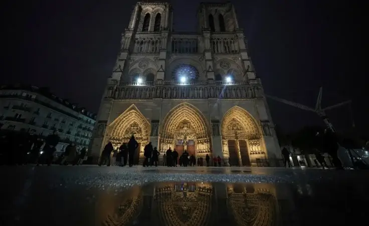 People arrive at Notre Dame Cathedral for the first public mass since the catastrophic fire of 2019, Sunday Dec. 8, 2024 in Paris. (AP Photo/Alessandra Tarantino)