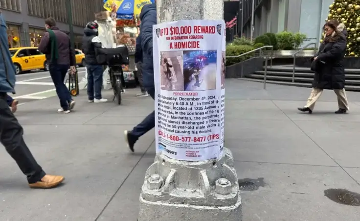 A reward poster hangs on a light pole outside the New York Hilton Midtown Hotel in New York on Thursday, December 5, 2024, where Brian Thompson, the CEO of UnitedHealthcare, was fatally shot on Wednesday. (AP Photo/Ted Shaffrey) Luigi Mangione