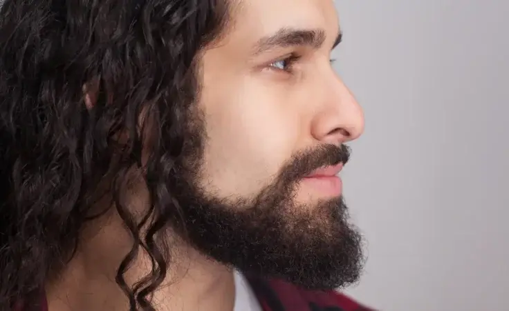 Side profile of man with long, curly hair and a short beard. By khosrork/stock.adobe.com. Jesus model, winter solstice