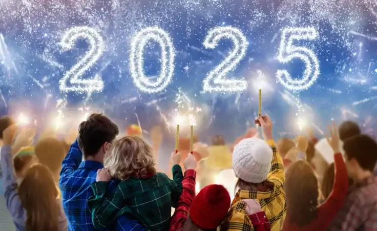 Family watching 2025 fireworks with sparklers. By famveldman/stock.adobe.com. New Year's traditions