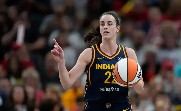 Indiana Fever's Caitlin Clark dribbles during the first half of a WNBA basketball game against the Seattle Storm, Sunday, Aug. 18, 2024, in Indianapolis. (AP Photo/Darron Cummings)