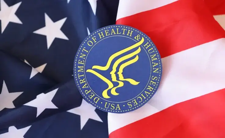 US Department of health and human services seal on the United States of America flag. By mehaniq41/stock.adobe.com. Robert F. Kennedy Jr.