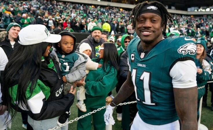 Philadelphia Eagle wide receiver A.J. Brown (11) looks on after talking with his son before an NFL wild-card playoff football game against the Green Bay Packers, Sunday, Jan. 12, 2025, in Philadelphia. (AP Photo/Chris Szagola)