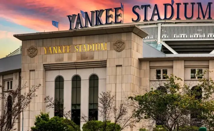 Entrance and sign at Yankee Stadium in the Bronx, one of the biggest ballparks with a beautiful sky at sunrise. By Domingo Sáez/stock.adobe.com