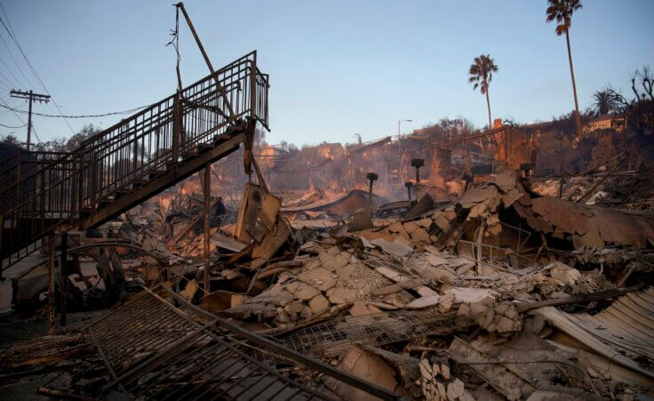 A staircase is left partially standing in a property in the aftermath of the Palisades Fire in the Pacific Palisades neighborhood of Los Angeles, Friday, Jan. 10, 2025. (AP Photo/John Locher)