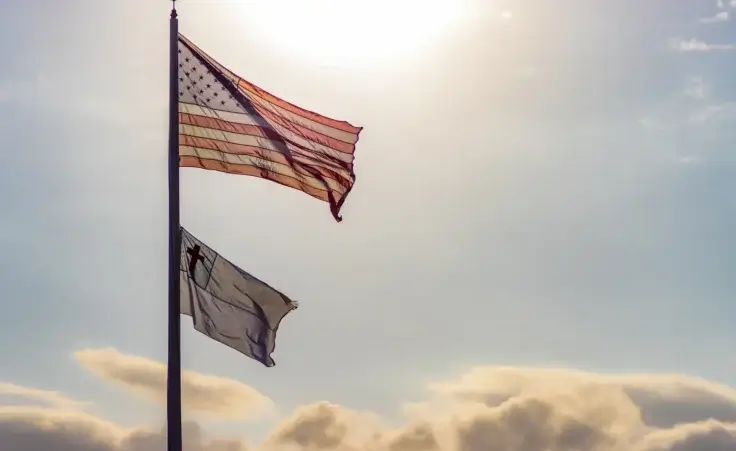 Christian and American flag near sunset. By Ajax9/stock.adobe.com. White house faith office